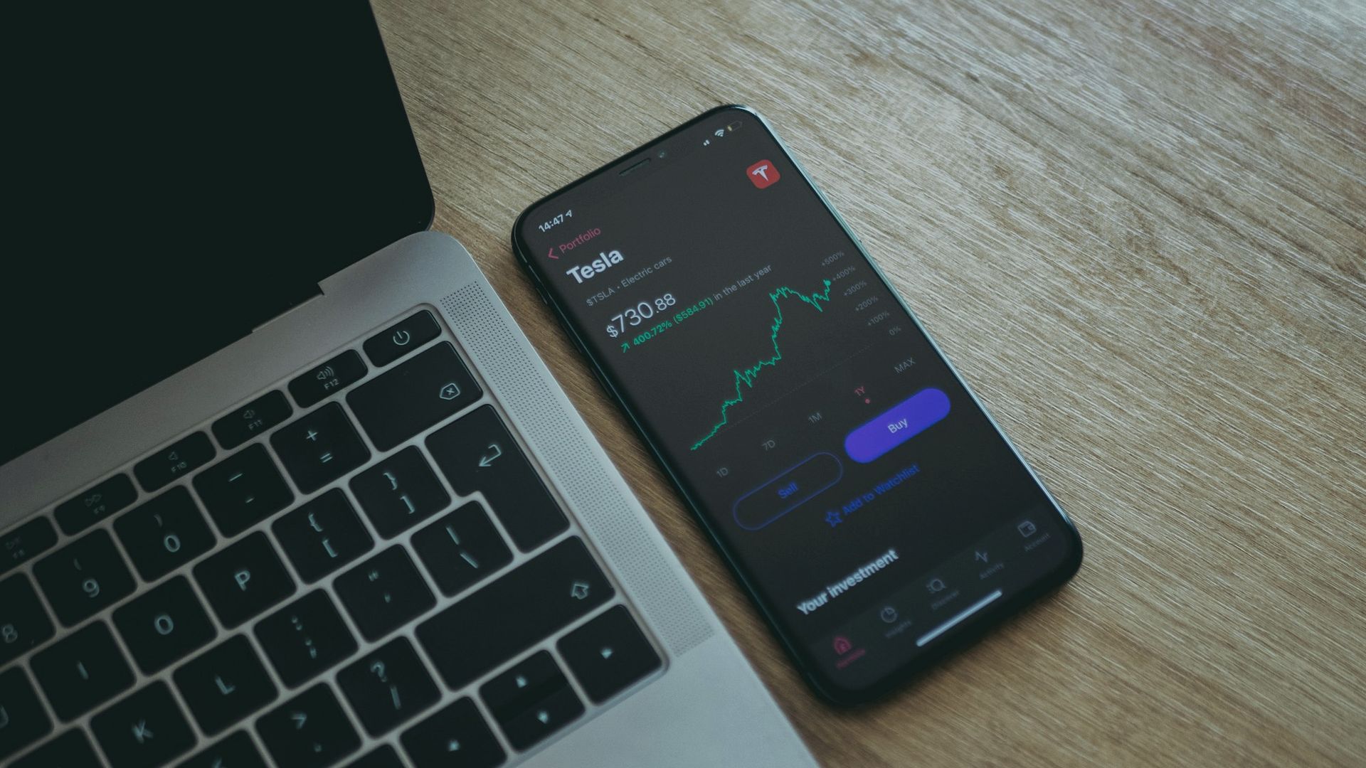Phone and laptop showing a USDT flash in a trading app